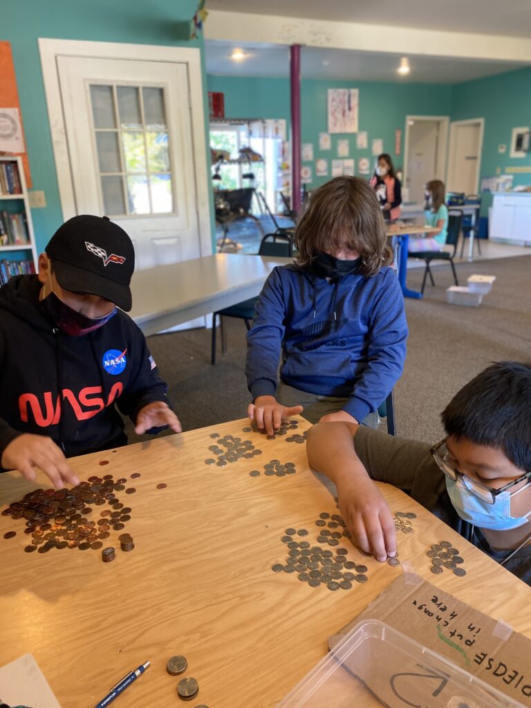 Older home center students counting money in Math